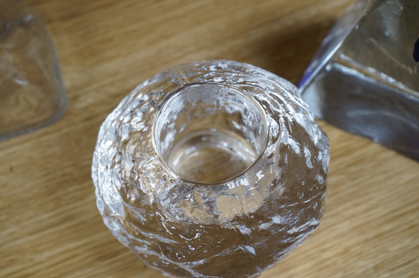 A collection of glassware including a Kosta Boda snowball pot and an Evian advertising water bottle, largest 23cm high